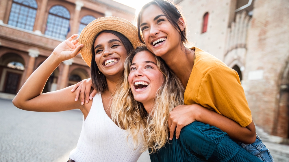 a group of multiracial young women smiling together