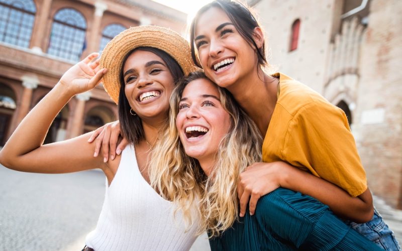 a group of multiracial young women smiling together